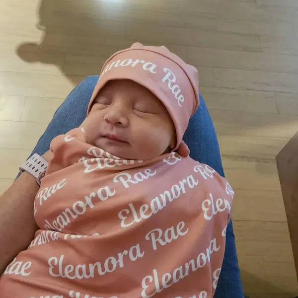 Bébé paisible enveloppé dans une couverture d'emmaillotage en coton doux.