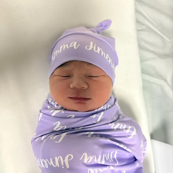 Bébé qui dort confortablement dans son berceau, bien enveloppé dans une couverture d'emmaillotage.